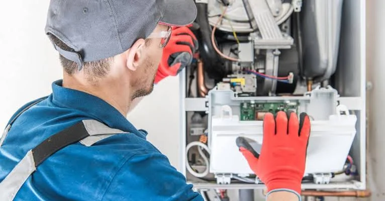 Heating technician inspecting a wall-mounted heating system